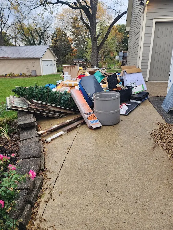 Dumpster being loaded with debris for 3 Yard Dumpster Rental in Little Falls